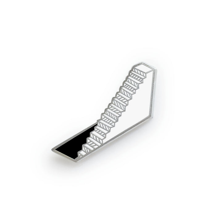 hard enamel pin, stair descending into a rectangular hole in the floor, silver outlines, white stairs, black hole
