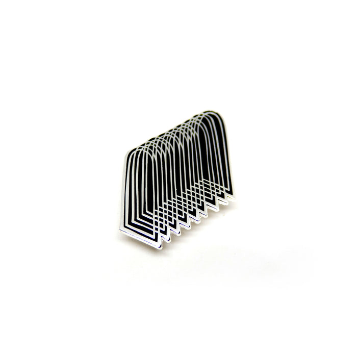 hard enamel pin of overlapping arches, silver colored intricate outlines on black 